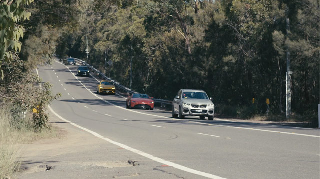 Cars In a Line, one behind the other,  Driving Down the Road